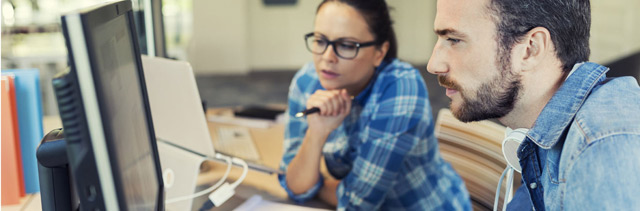 Young man and woman studying computer screen for customer relationship management, CRM.