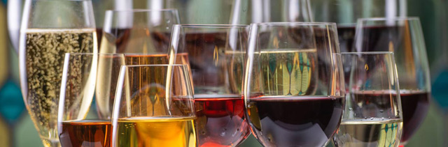 Multiple wine and champagne glasses lined up to represent the features of VinNOW