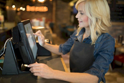 Female using the touch screen to update customer records.