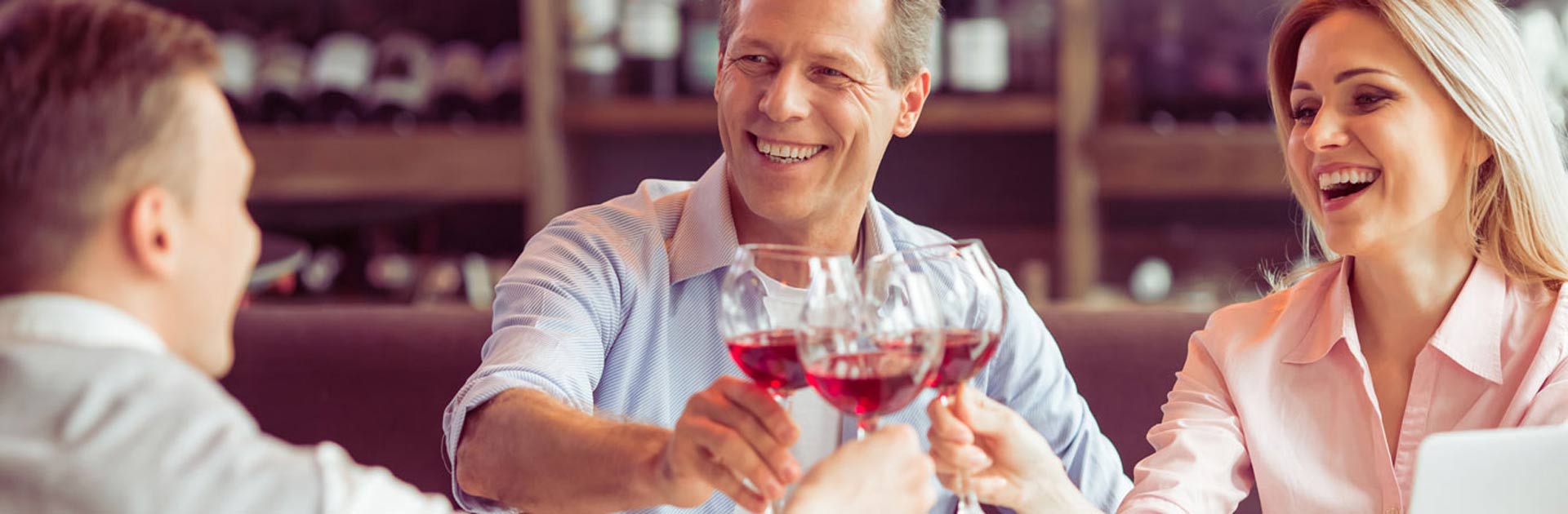 A couple toasts with the sommelier enjoying a rose wine.